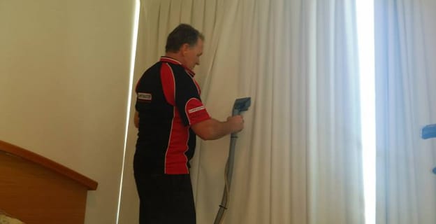 Man Dry Cleaning the Curtains — Upholstery & Carpet Cleaning on the Marcoola, QLD