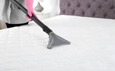 Woman Cleaning White Mattress — Upholstery & Carpet Cleaning on the Sunshine Coast, QLD