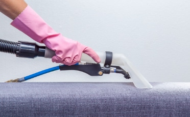 Person in A Pink Glove Holding a Vacuum Cleaner — Upholstery & Carpet Cleaning on the Sunshine Coast, QLD