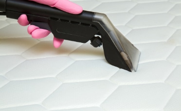 Close-up of Hand Cleaning Mattress — Upholstery & Carpet Cleaning on the Sunshine Coast, QLD