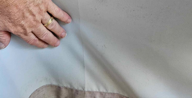 Man Hands Showing Dirty Curtains — Upholstery & Carpet Cleaning on the Noosa, QLD