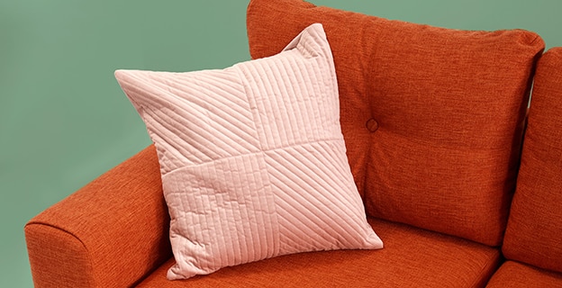 Orange Sofa with Pink Pillow — Upholstery & Carpet Cleaning on the Bli Bli, QLD