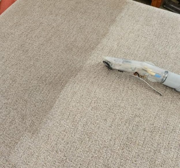 A Vacuum Cleaner on A Couch — Upholstery & Carpet Cleaning on the Sunshine Coast, QLD