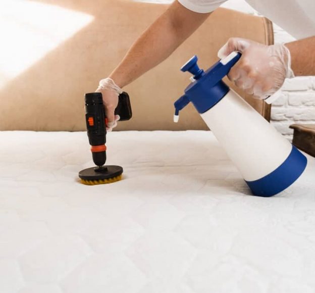 Spraying and Smearing Detergent on White Mattress — Upholstery & Carpet Cleaning on the Peregian Beach, QLD